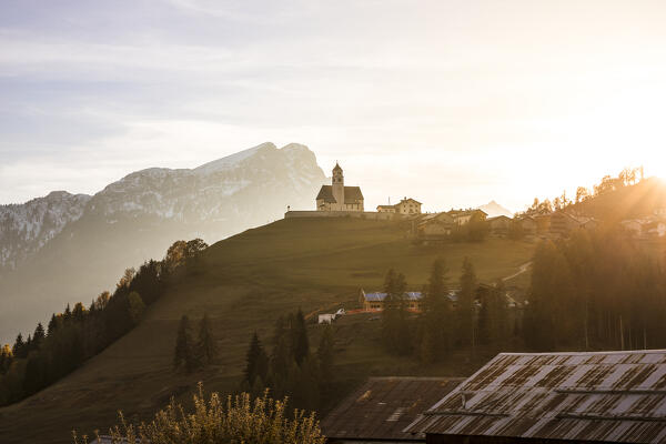 Italy, Veneto, province of Belluno,the iconic church of Colle Santa Lucia at sunset
