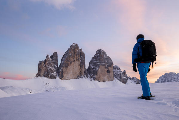 A man looks at the sunset at the Three Peaks,Bolzano district,South Tyrol,Italy,Europe