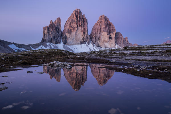 Three Peaks reflected in a puddle at dawn, Natural Park Three Peaks,Sesto Pusteria,Bolzano district, South Tyrol,Italy,Europe