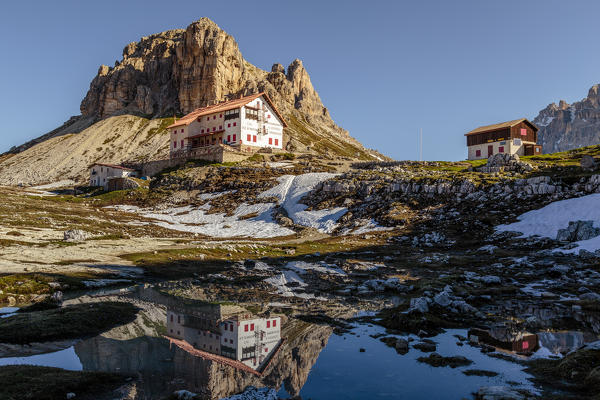 Locatelli refuge reflected in a puddle, Natural Park Three Peaks, Sesto Pusteria, Bolzano district, South Tyrol, Italy, Europe