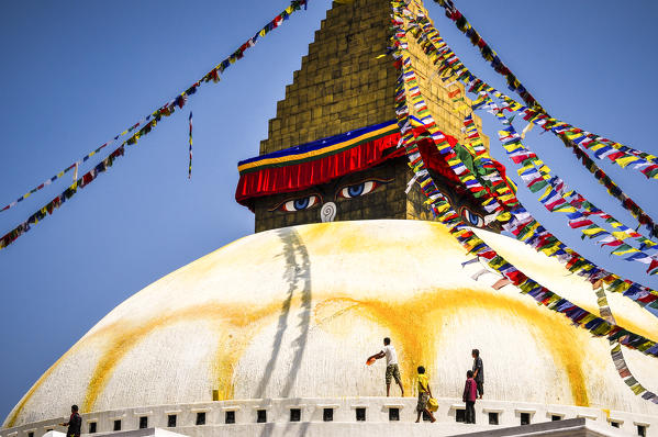 Bouddhanath Stupa with men refreshing yellow color,Kathmandu,Nepal,Asia 