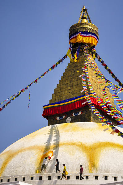 Bouddhanath Stupa with men refreshing yellow color,Kathmandu,Nepal,Asia 