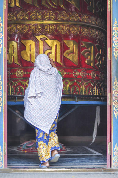 Local woman is going to around a prayer wheel,Swayambhunath ,Kathmandu Valley,Nepal,Asia