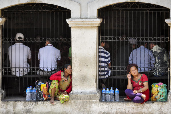 Water peddlers rest in the shadow,Pashupatinath Temple,Kathmandu,Nepal,Asia