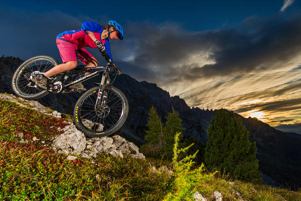 Europe,Dolomites,Italy,Trentino AltoAdige,Latemar,Carezza.
Mountain bikers at sunset