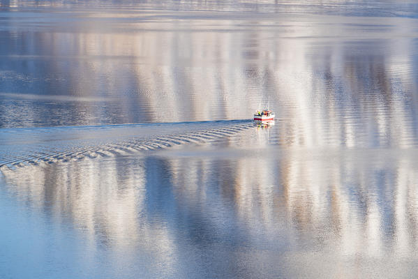 Fishing boat on the sea in Austnesfjord. Vestpollen, Nordland county, Northern Norway region, Norway.
