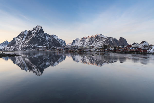 Mountain reflection at Reine Bay at sunset in winter. Reine, Nordland county, Northern Norway, Norway.