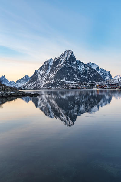 Mountain reflection at Reine Bay at sunset in winter. Reine, Nordland county, Northern Norway, Norway.
