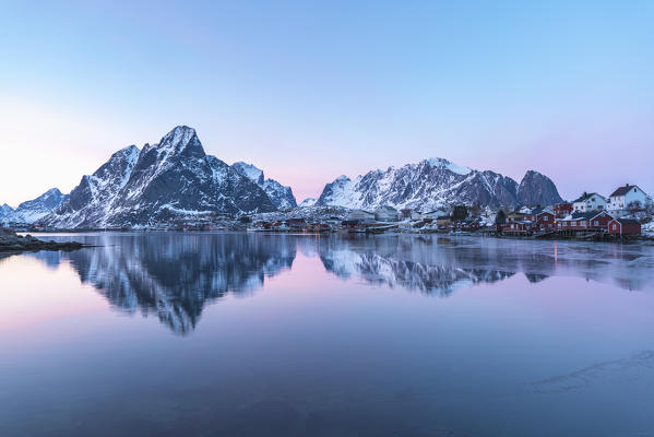 Mountain reflection at Reine Bay at sunset in winter. Reine, Nordland county, Northern Norway, Norway.