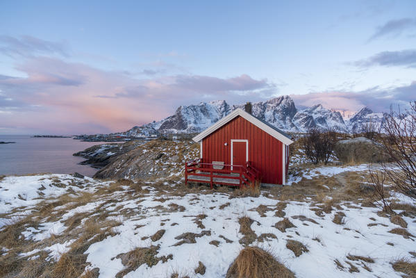 Traditional fishermen house in winter at dawn. Hamnoy, Nordland county, Northern Norway, Norway.