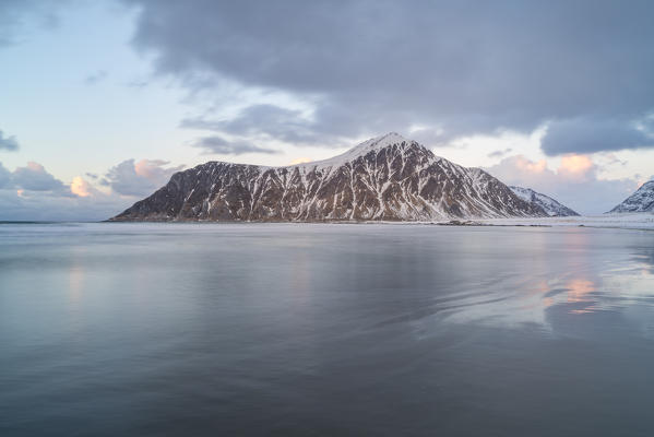 Skagsanden beach and Knubban peak in winter at sunset. Flakstad, Nordland county, Northern Norway, Norway.