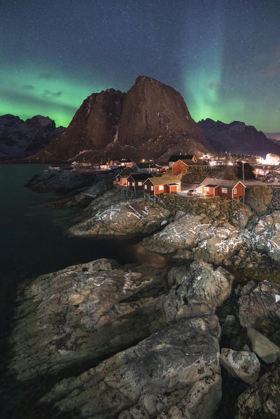 Northern lights in the sky over the village. Hamnoy, Nordland county, Northern Norway, Norway.