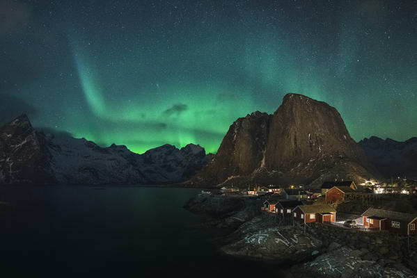 Northern lights in the sky over the village. Hamnoy, Nordland county, Northern Norway, Norway.