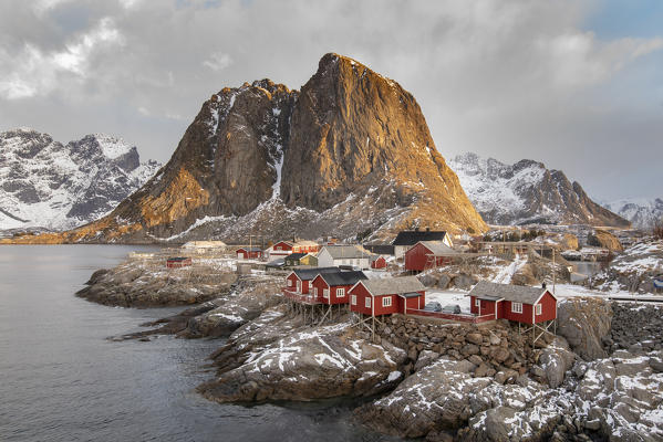 The fishing village with its traditional 'rorbus' at dawn in winter. Hamnoy, Nordland county, Northern Norway, Norway.