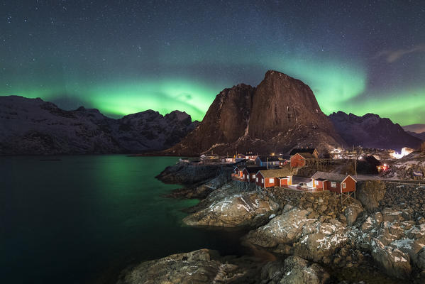 Northern lights in the sky over the village. Hamnoy, Nordland county, Northern Norway, Norway.
