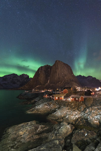 Northern lights in the sky over the village. Hamnoy, Nordland county, Northern Norway, Norway.