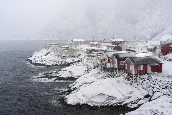 Close-up on Hamnoy village under the snow, with Festheltinden mountain in the background. Moskenes municipality, Nordland county, Northern Norway, Norway.