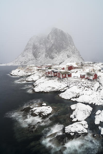 Hamnoy village under the snow, with Festheltinden peak in the background. Moskenes municipality, Nordland county, Northern Norway, Norway.