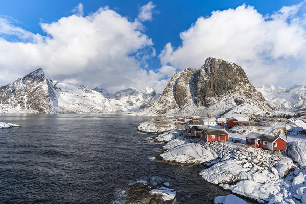 Hamnoy village covered in snow, with Festheltinden and Olstinden peaks in the background. Moskenes municipality, Nordland county, Northern Norway, Norway.