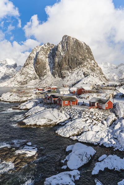 Hamnoy village covered in snow, with Festheltinden peak in the background. Moskenes municipality, Nordland county, Northern Norway, Norway.