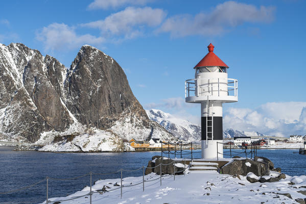 Lighthouse with Festheltinden peak and the village in the background. Reine, Nordland county, Northern Norway region, Norway.
