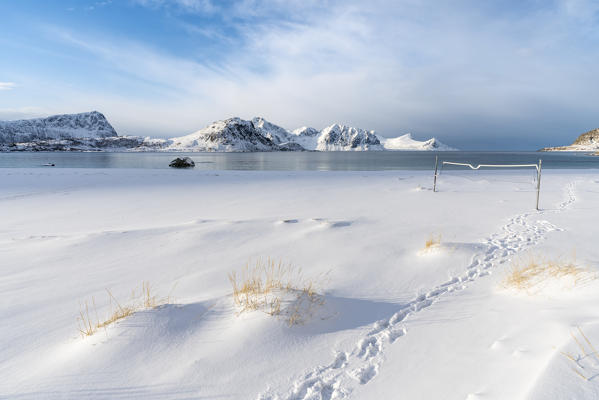 Volley net on Haukland Beach in winter, with mountains in the background. Leknes, Nordland county, Northern Norway, Norway.