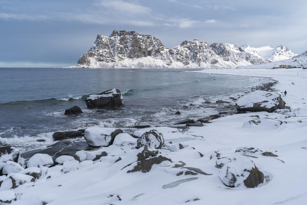 Uttakleiv Beach, with rocks in the fore and mountains in the background. Leknes, Nordland county, Northern Norway, Norway.