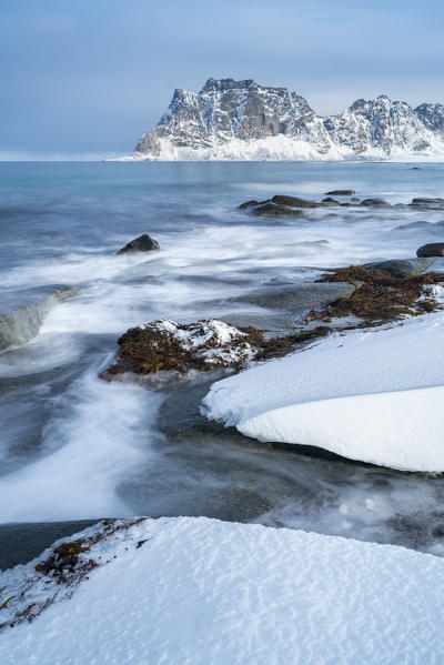 Uttakleiv Beach, with rocks in the fore and mountains in the background. Leknes, Nordland county, Northern Norway, Norway.