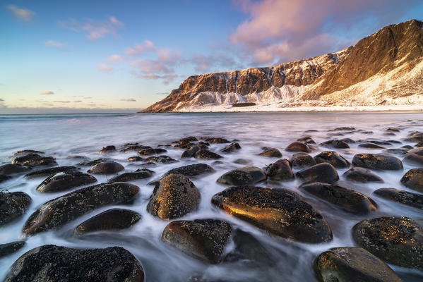 Unstad Beach with Kleivheia mountain in the background in winter at sunset. Vestvagoy municipality, Nordland county, Northern Norway, Norway.