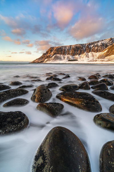 Unstad Beach with Kleivheia mountain in the background in winter at sunset. Vestvagoy municipality, Nordland county, Northern Norway, Norway.