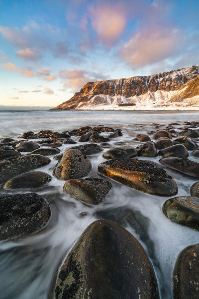 Unstad Beach with Kleivheia mountain in the background in winter at sunset. Vestvagoy municipality, Nordland county, Northern Norway, Norway.