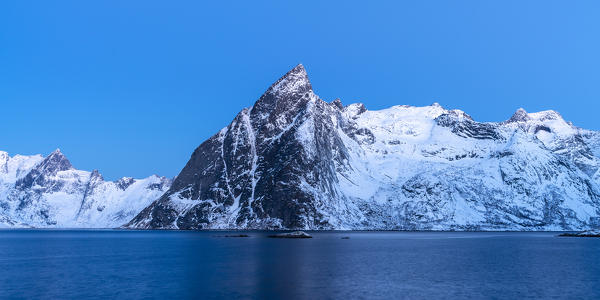 Olstinden peak at dusk in winter, shot from Hamnoy. Reine, Nordland county, Northern Norway, Norway.