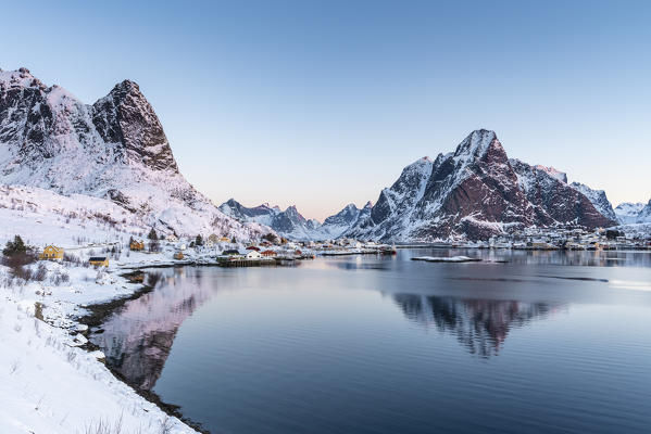 Reine fjord at dawn, with Navaren and Olstinden peaks in winter. Reine, Nordland county, Northern Norway, Norway.