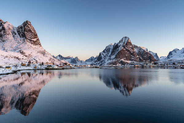 Reine fjord at dawn, with Navaren and Olstinden peaks in winter. Reine, Nordland county, Northern Norway, Norway.