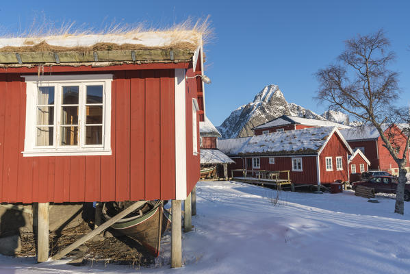 Traditional 'rorbu' houses, with Olstinden peak in the background. Reine, Nordland county, Northern Norway, Norway.
