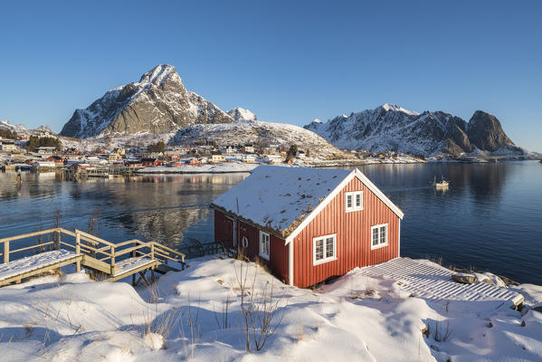 Traditional 'rorbu' house, with  Olstinden peak in the background. Reine, Nordland county, Northern Norway, Norway.