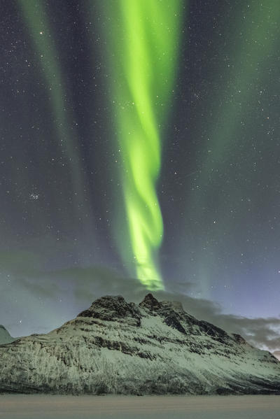 Northern lights in the sky above Skoddebergvatnet lake. Grovfjord, Troms county, Northern Norway, Norway.