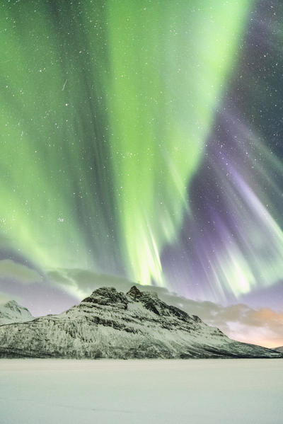 Northern lights in the sky above Skoddebergvatnet lake, Grovfjord, Troms county, Northern Norway, Norway.