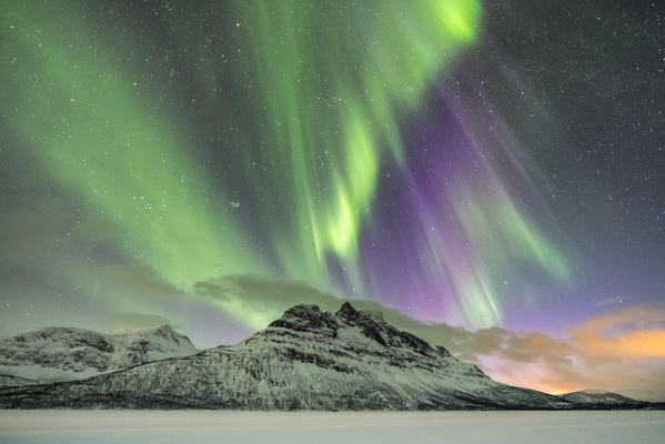 Northern lights in the sky above Skoddebergvatnet lake. Grovfjord, Troms county, Northern Norway, Norway.