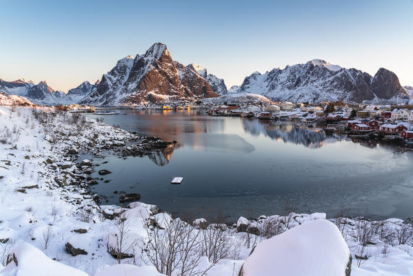 Reine fjord at dawn, with Olstinden, Lilandstinden and Festheltinden peaks in winter. Reine, Nordland county, Northern Norway, Norway.