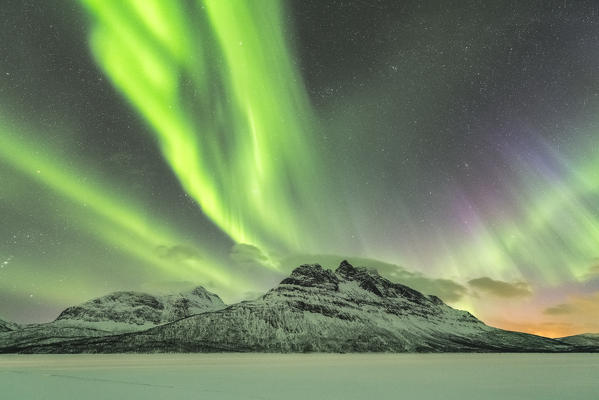 Northern lights in the sky above Skoddebergvatnet lake. Grovfjord, Troms county, Northern Norway, Norway.