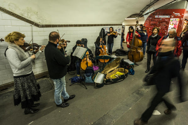 A group of street musicians perform in the Paris subway.Paris, France