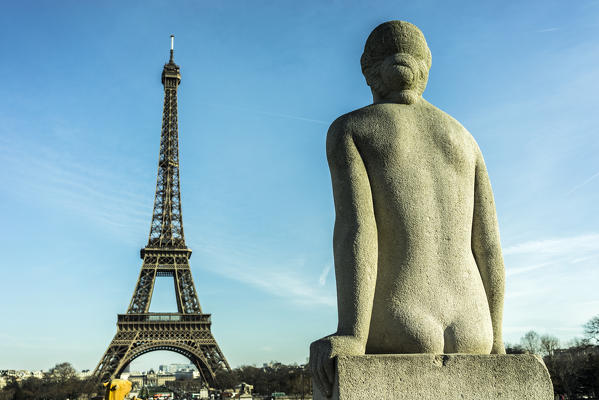 A female statue facing the Paris Eiffel tower in Paris, France