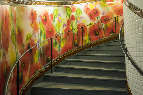 Abbesses: painted mural and spiral staircase. Station Abbesses Paris, France.
