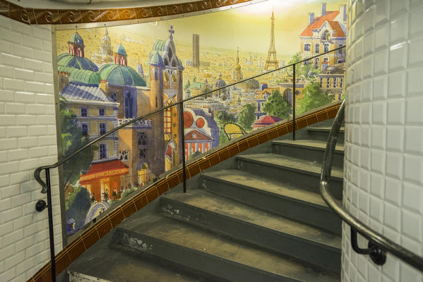 Abbesses: painted mural and spiral staircase. Station Abbesses, Paris, France