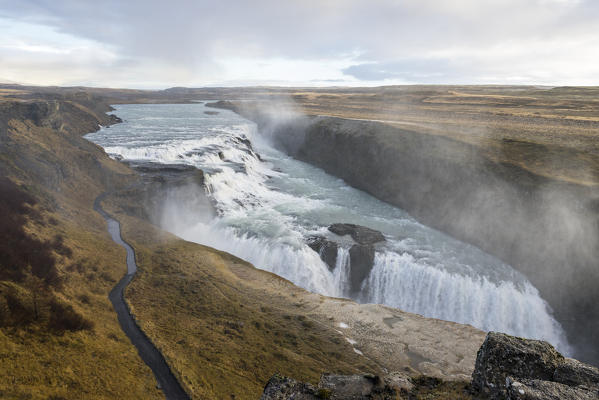 Landscape with Gullfoss waterfall, steam and road. Hrunamannahreppur, Arnessysla, Sudurland, Iceland, Europe.