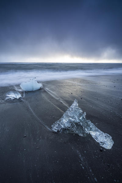 Ice blocks on the black sand beach in Jokulsarlon Glacier Lagoon, Eastern Iceland, Europe