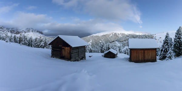 Two wooden lodges covered in snow. Passo delle Erbe, Bolzano, Trentino Alto Adige - Sudtirol, Italy, Europe.