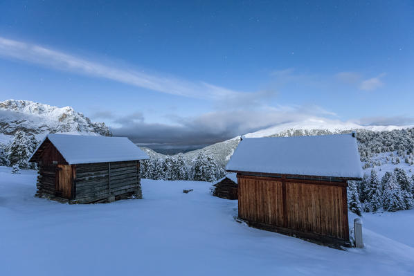 Two wooden lodges covered in snow. Passo delle Erbe, Bolzano, Trentino Alto Adige - Sudtirol, Italy, Europe.