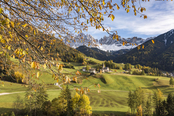 Dolomites village framed by autumnal leaves. Santa Maddalena, Funes, Bolzano, Trentino Alto Adige - Sudtirol, Italy, Europe
